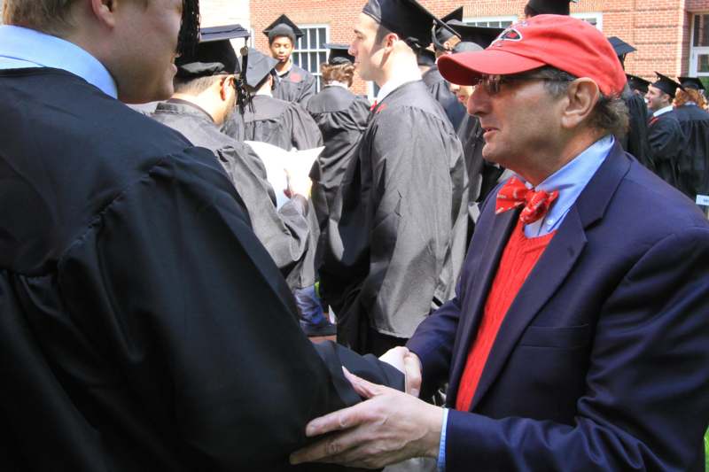 a man shaking hands with other people