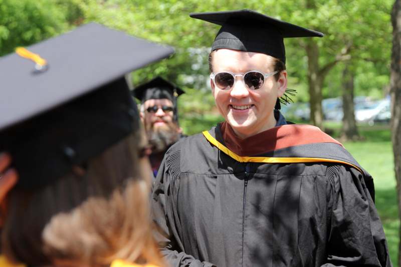 a man in a graduation gown and cap