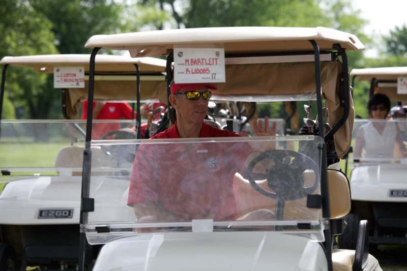 a man driving a golf cart