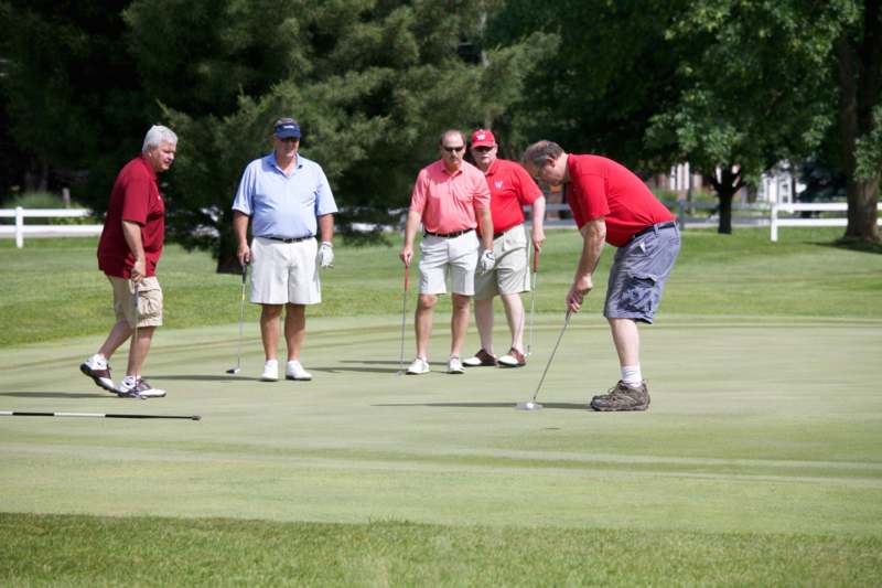 a group of men playing golf
