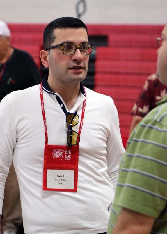 a man wearing a name tag and glasses