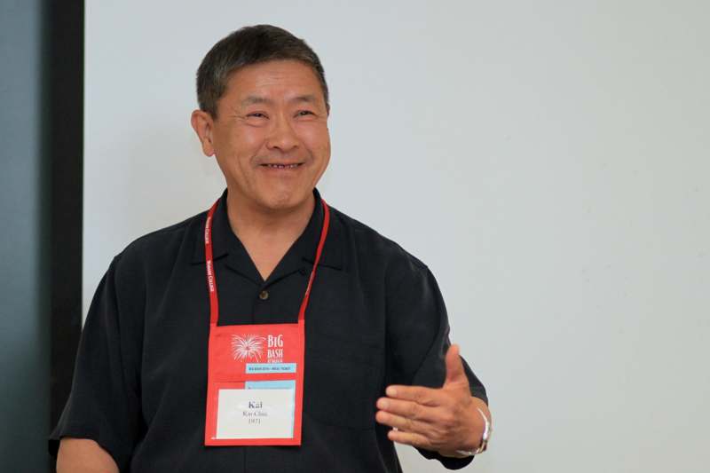 a man wearing a lanyard and smiling