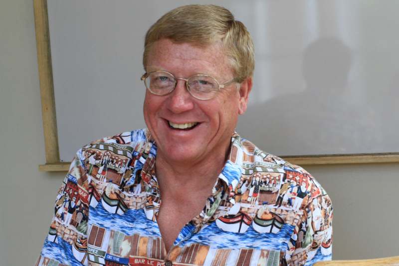 a man wearing glasses and a hawaiian shirt
