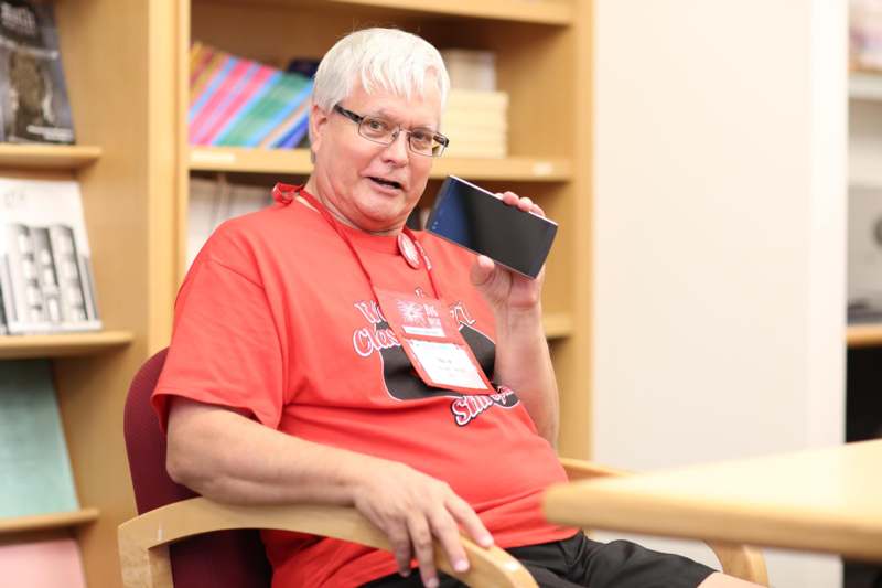 a man sitting in a chair holding a phone