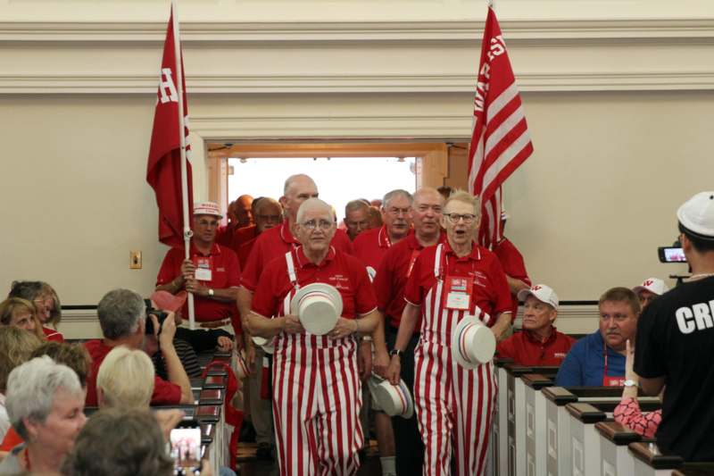 a group of people in matching red and white striped outfits