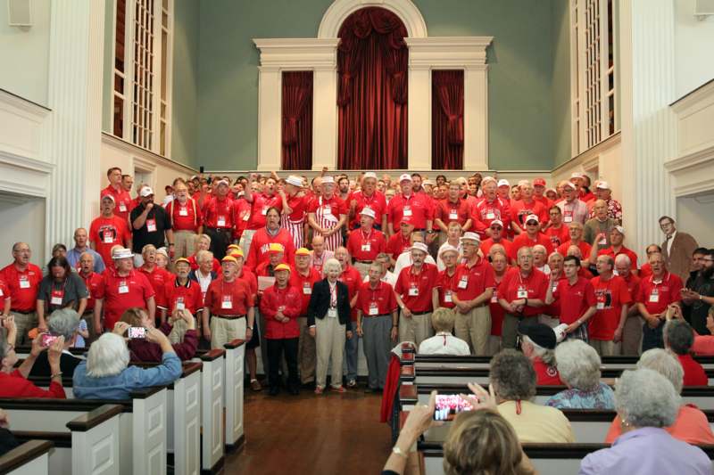 a group of people in red shirts