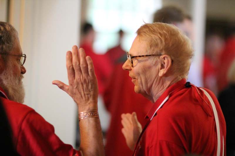 a man in red shirt clapping