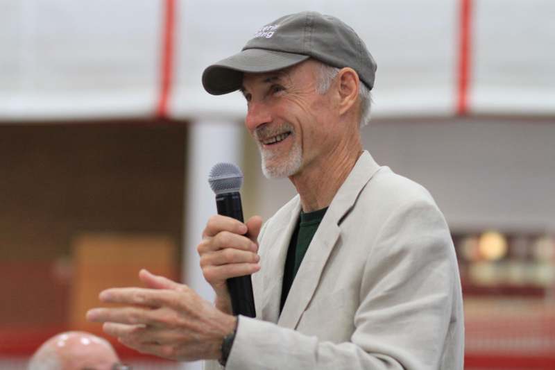 a man in a hat holding a microphone