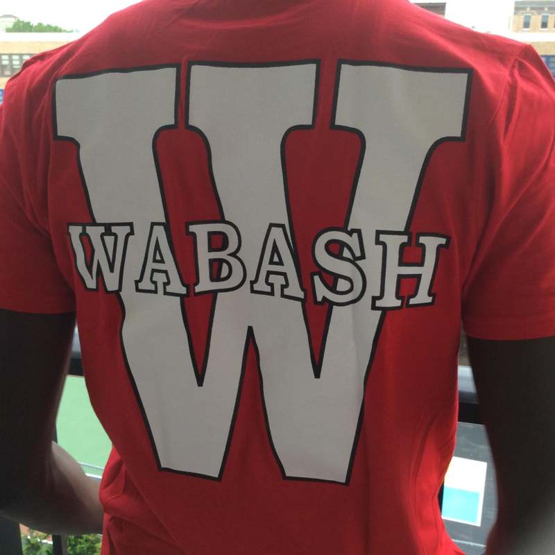 a person wearing a red shirt with white letters on it