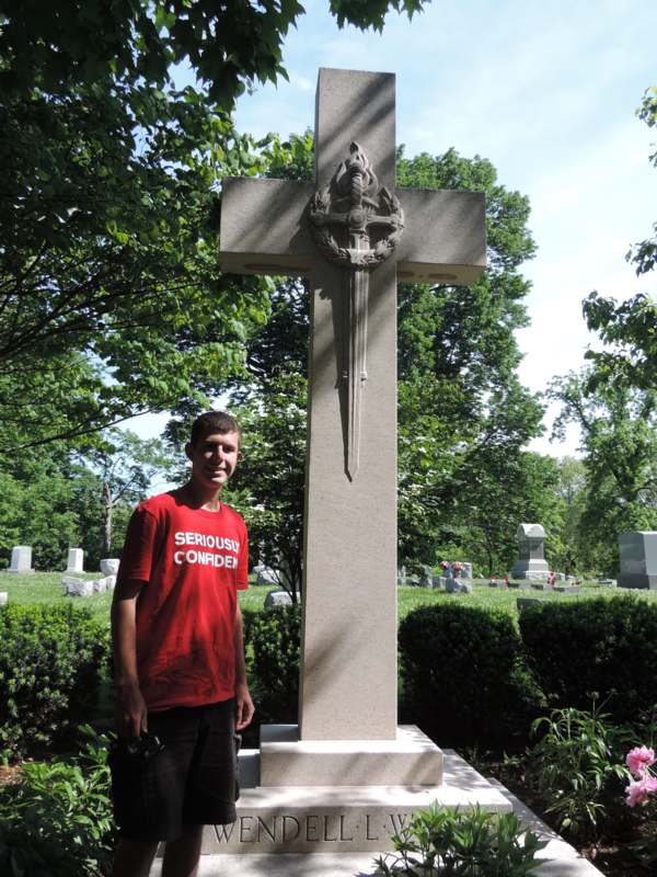 a man standing next to a cross