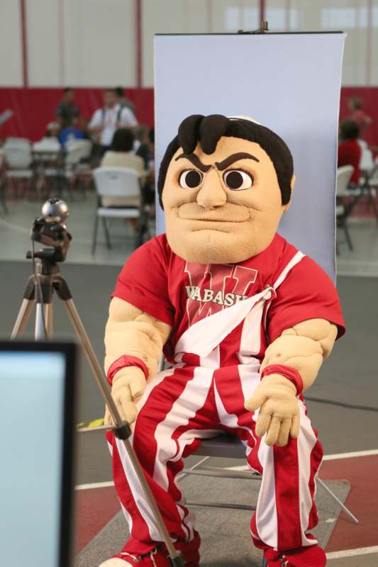 a person wearing a red and white uniform sitting on a chair