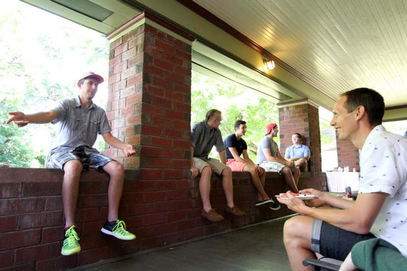 a group of people sitting on a porch