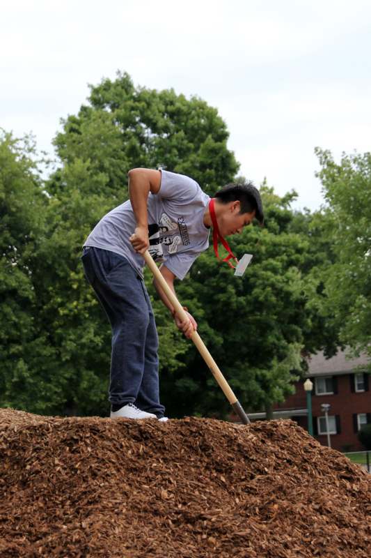 a man digging in dirt with a shovel