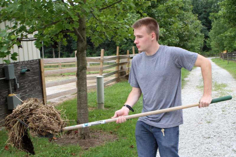 a man holding a rake
