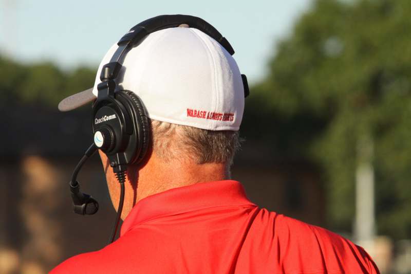 a man wearing a white hat with headphones