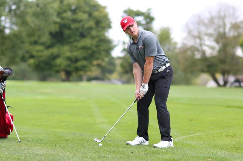 a man in a red hat playing golf