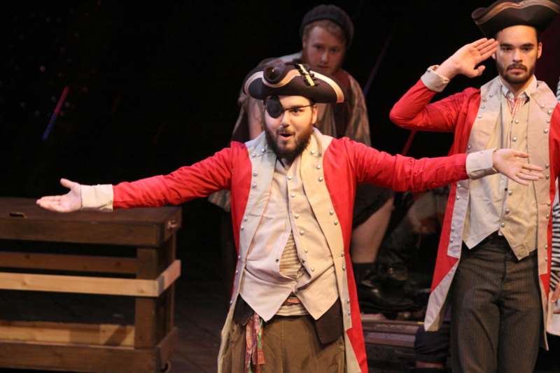 a man in pirate garment with his arms out