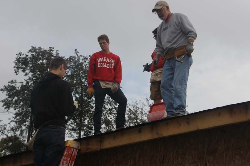 a group of men standing on a roof
