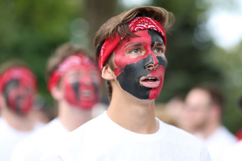 a man with red and black face paint