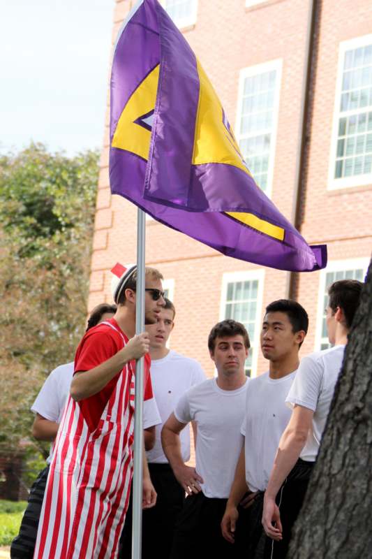 a group of people standing around a flag