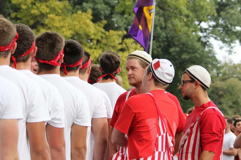 a group of people wearing red and white outfits