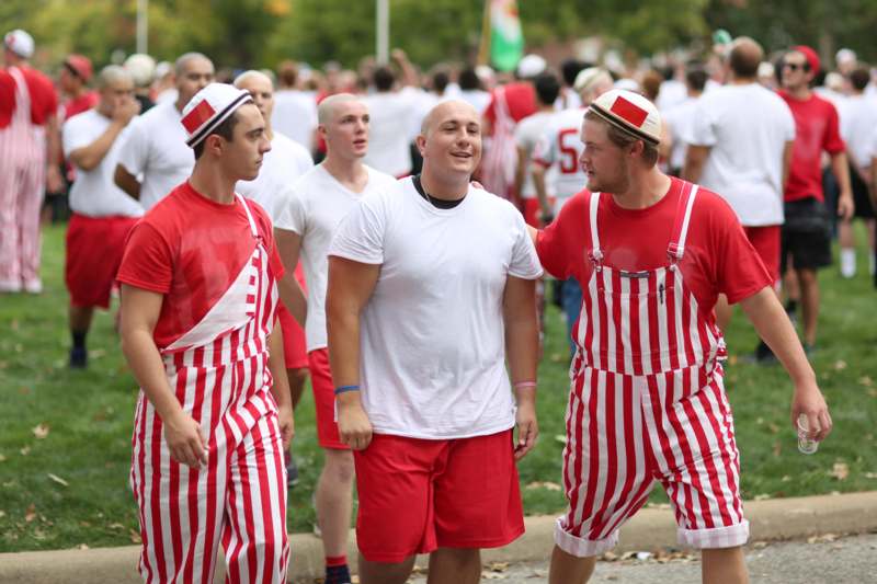 a group of men in red and white striped outfits