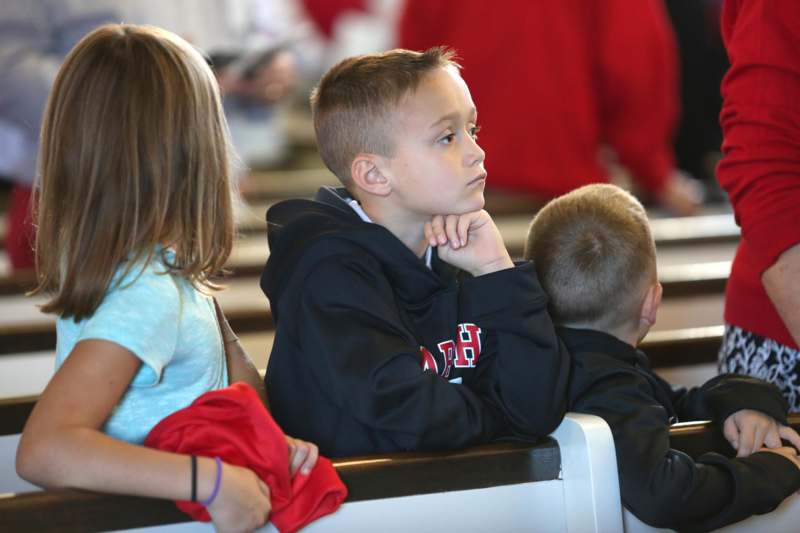 a group of children sitting in pews