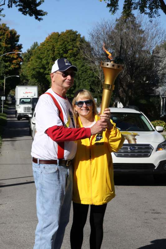 a man and woman holding a torch