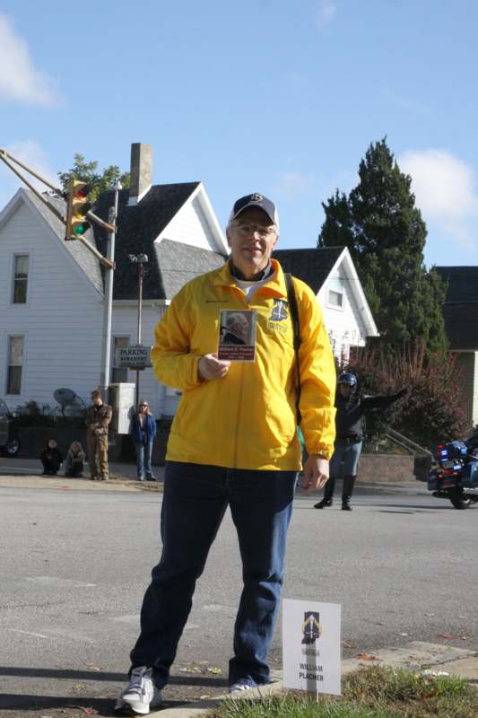 a man in a yellow jacket holding a badge
