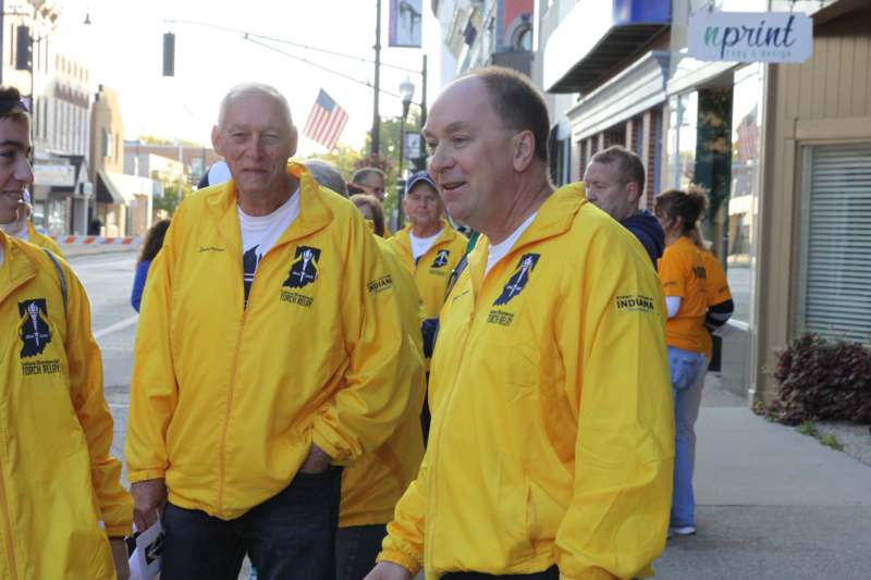 a group of men wearing yellow jackets