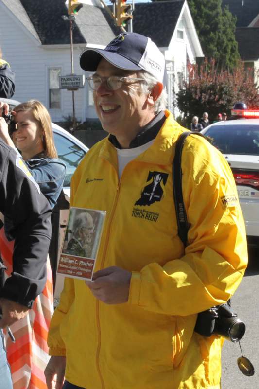 a man in a yellow jacket holding a picture