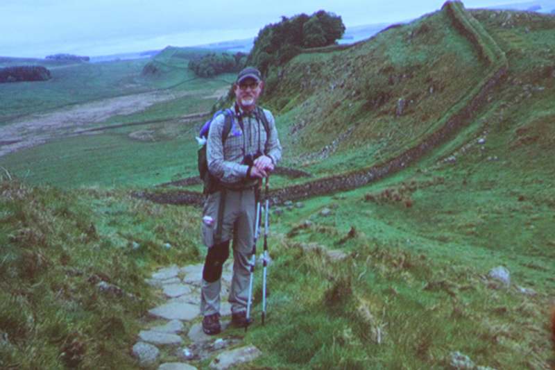 a man standing on a path with poles