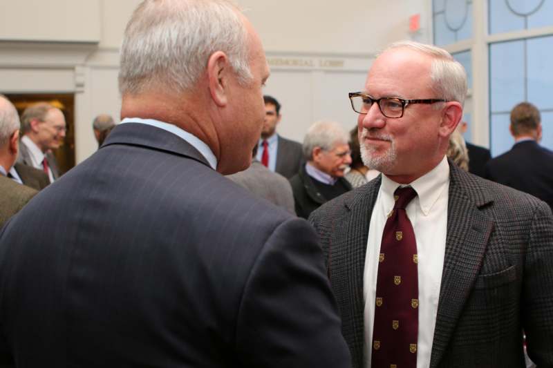 a man in a suit talking to another man