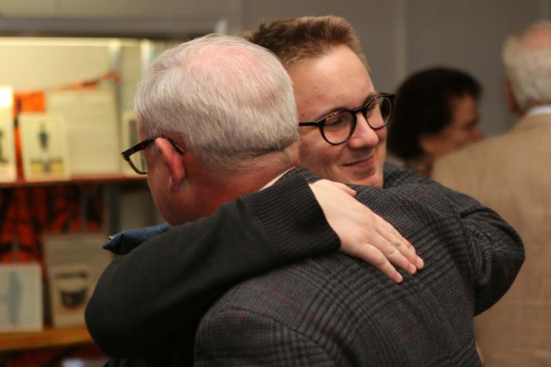 a man hugging another man