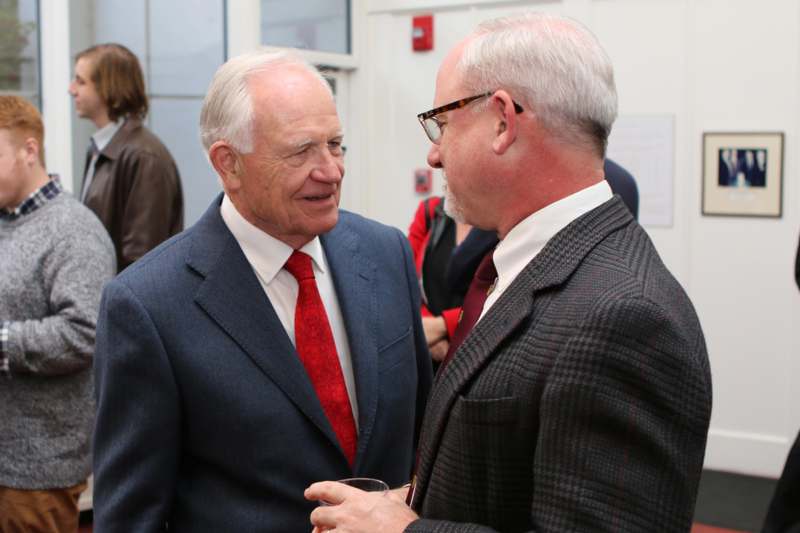 two men in suits talking