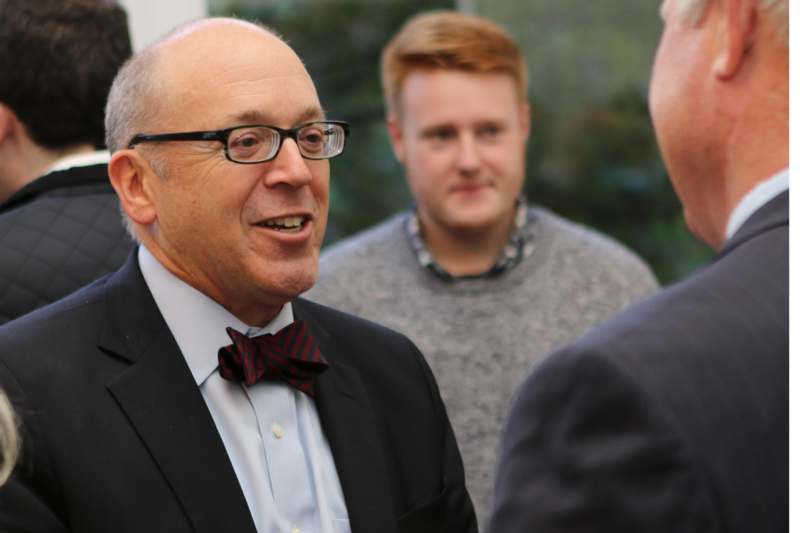 a man in a suit and bow tie