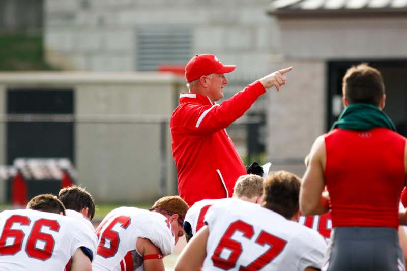 a football coach pointing at his players