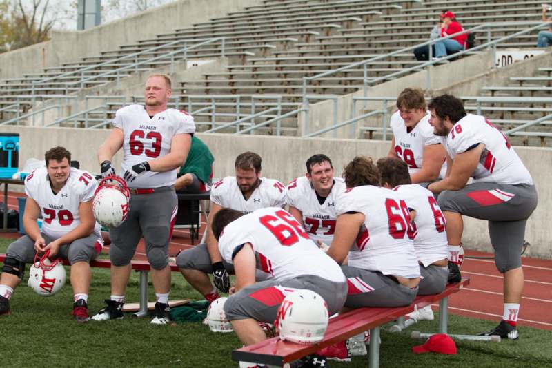 a group of football players sitting on a bench