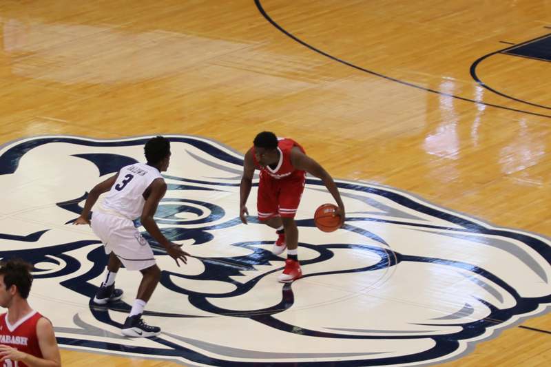 a basketball player dribbling a ball on a basketball court