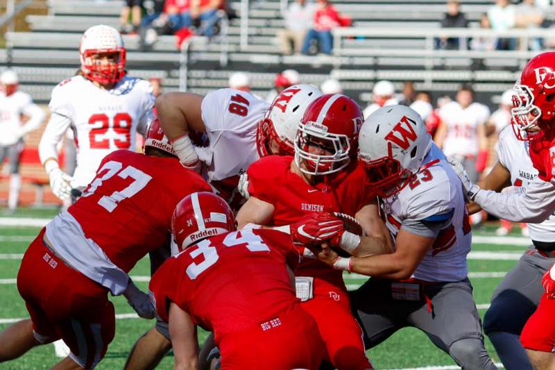 a group of football players in red and white uniforms