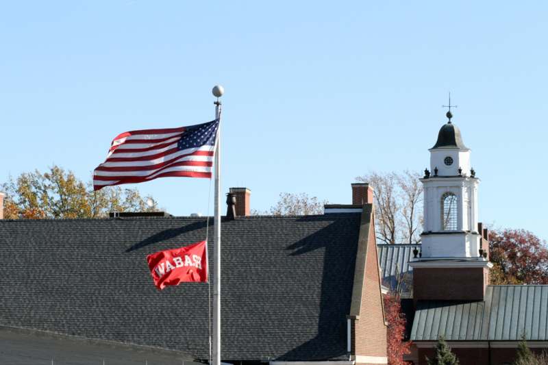 a flagpole with a flag on it and a flag on the top of a building