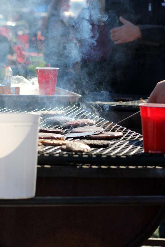 a grill with meat and drinks
