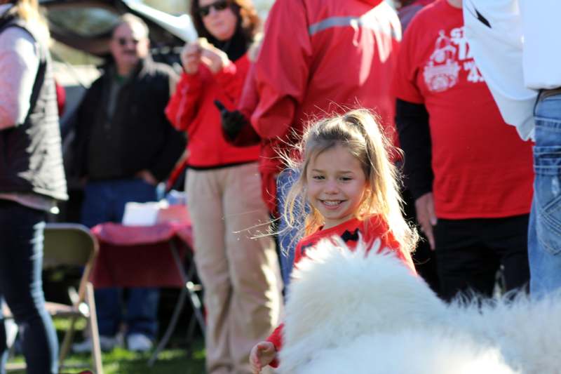a girl in red shirt with a dog