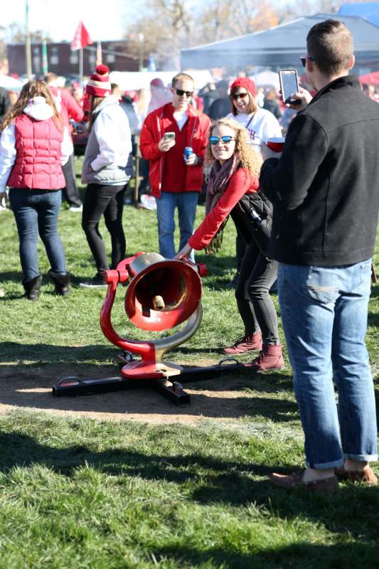 a woman leaning over a red cannon