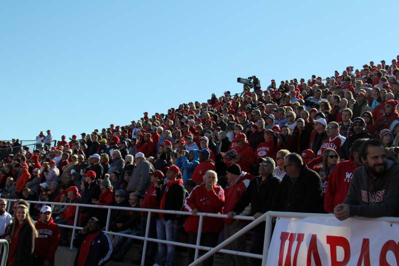a large crowd of people in red and black