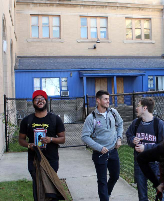 a group of men standing outside a building