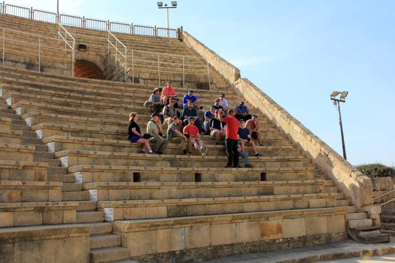 a group of people sitting on a stone stairs