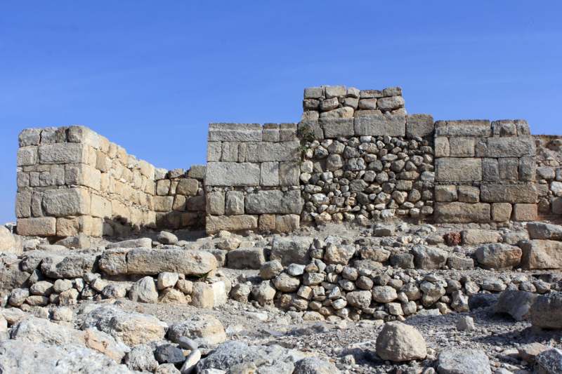 a stone wall with a few blocks of stone