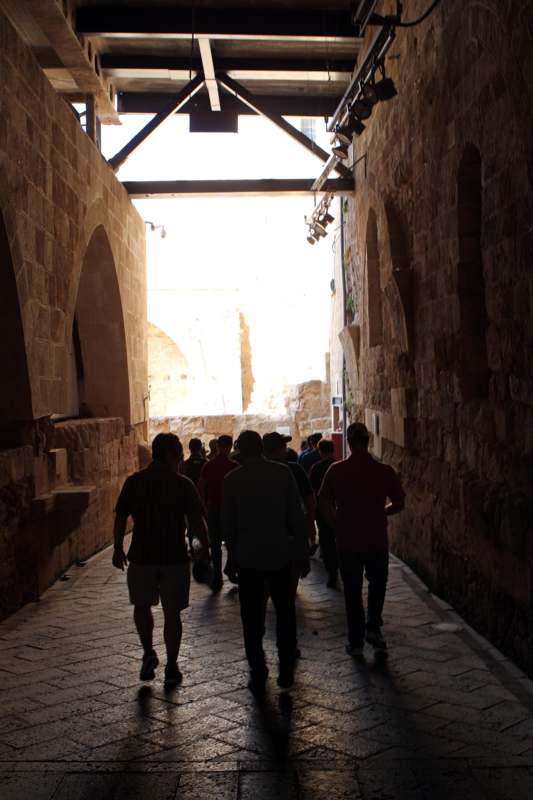 a group of people walking in a narrow alley