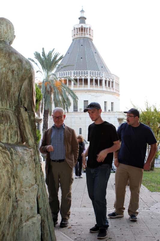a group of men walking by a statue